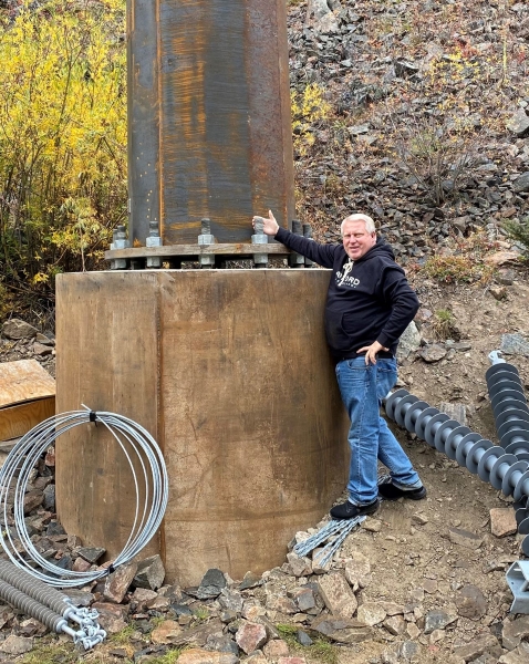 Pinocci standing next to a new transmission pole.